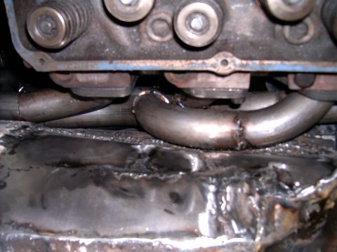 1978 Ford Mustang II - Custom exhaust headers are welded and fitted onto the engine block, showing the intricate pipework.