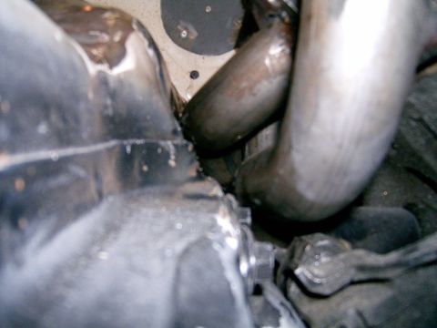 1978 Ford Mustang II - Close-up view of exhaust headers in an engine bay, likely from a vintage vehicle.