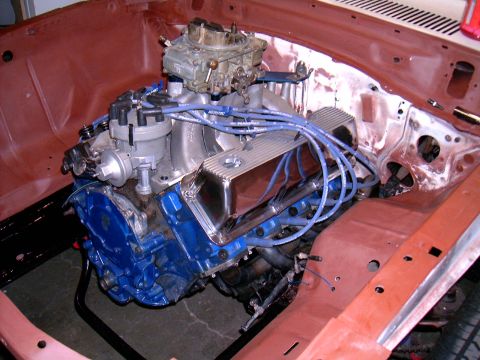 1978 Ford Mustang II - V8 engine with blue block and chrome valve covers in a car's engine bay.