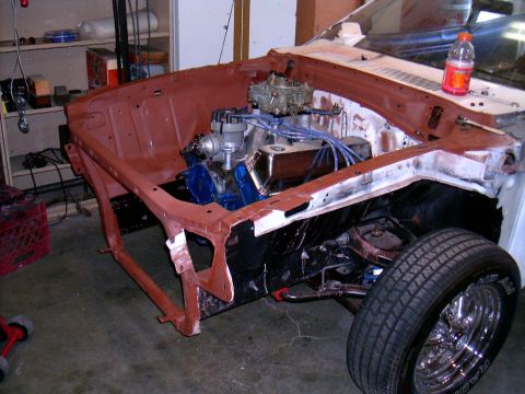 1978 Ford Mustang II - The engine bay of a 1978 Ford Mustang II is shown during restoration, with the V8 engine and front suspension visible.