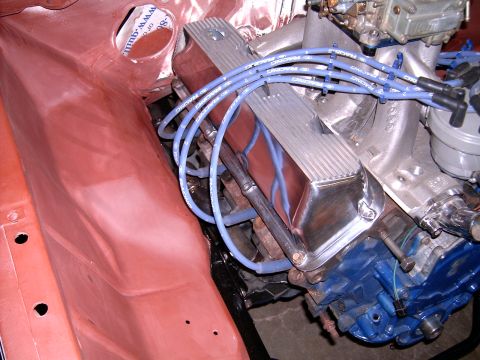 1978 Ford Mustang II - Close-up of an engine bay with chrome valve covers and blue spark plug wires.