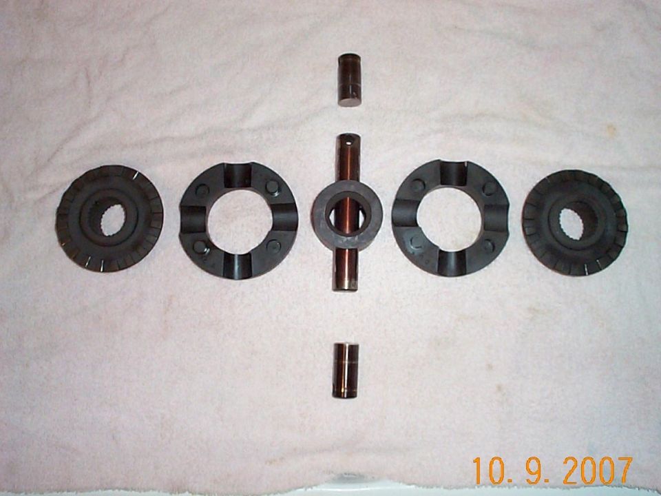 Differential locker internals on a towel: side gears, spacers and cross shaft