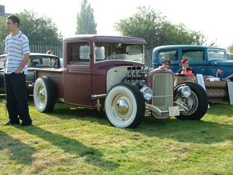 1988 Ford Sport - Custom hot rod pickup truck with a V8 engine and whitewall tires on display at an outdoor event.