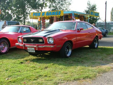1988 Ford Sport - Red 1975 Ford Mustang II coupe with black hood scoop and custom wheels.