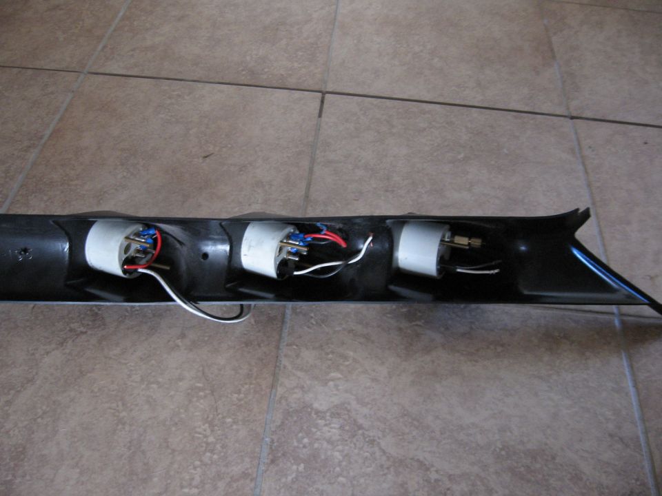 Black gauge pod with three gauge openings and wiring