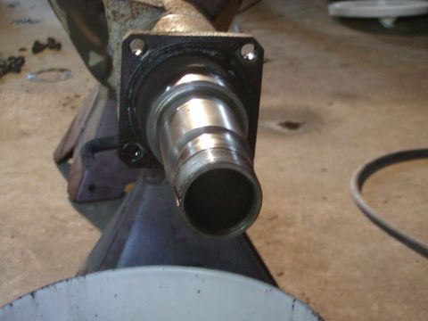 1991 Ford Bronco - A close-up view of a vehicle's axle assembly, resting on a jack stand in a garage setting.