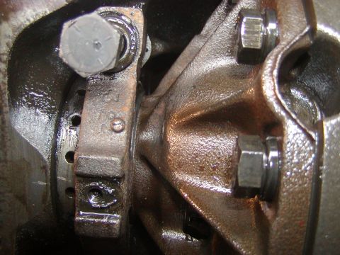 1991 Ford Bronco - Detail of an engine component, showing bolts and lubrication. The registry information may be inaccurate.