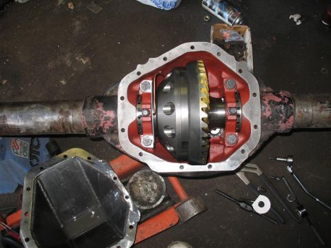 1991 Ford Bronco - Close-up of an open differential housing and its internal gears, with tools scattered around.