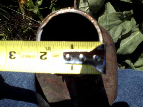 1996 Mercury Grand Marquis - Measuring the diameter of a rusty pipe with a yellow Stanley tape measure.