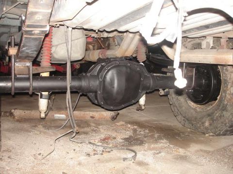 1996 Ford F-150 - Underneath view of a truck's rear axle and suspension system, showing leaf springs and shocks.