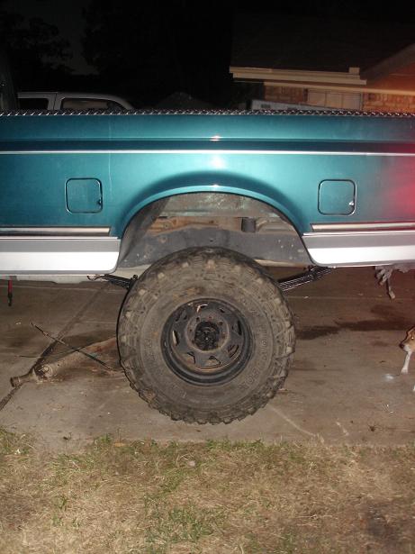 1996 Ford F-150 - Rear side view of a 1996 Ford F-150 pickup truck, showing the wheel and fender.