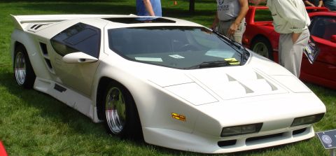1994 Ford Bronco - A white Vector M12 is parked on grass with another red sports car visible in the background.