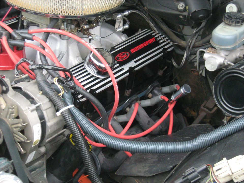 Ford Motorsport valve cover on V8 with red plug wires