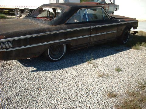1963 Ford Galaxie - This rusty 1963 Ford Galaxie 500 is parked on a gravel lot next to another vehicle.