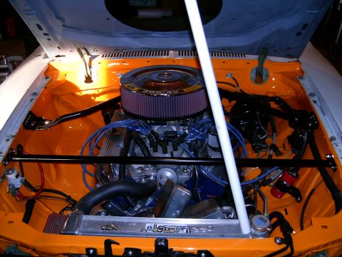 1978 Ford Mustang II - V8 engine in a car's engine bay, an aftermarket air filter and aluminum radiator.