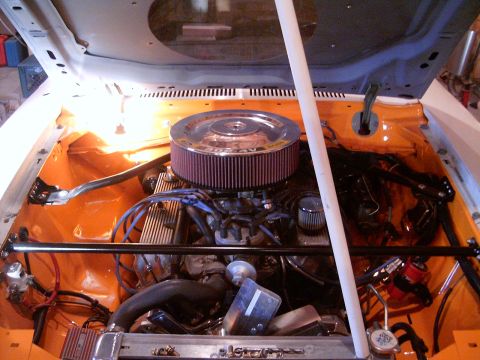1978 Ford Mustang II - The engine bay is painted orange and features a V8 engine with a chrome air filter housing.