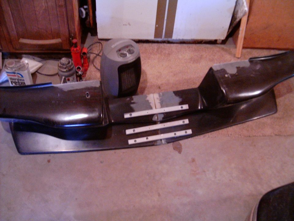 Dark car bumper with metal mounting strips