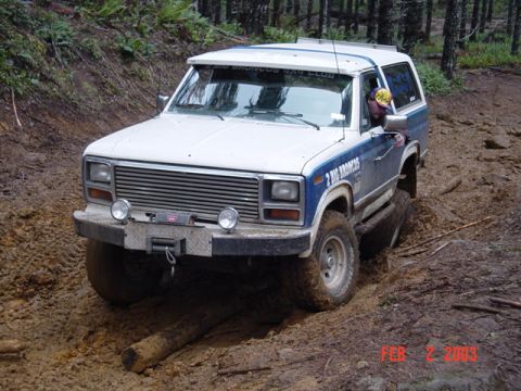 1985 Ford Bronco - This 1985 Ford Bronco is shown off-roading on a challenging muddy course.