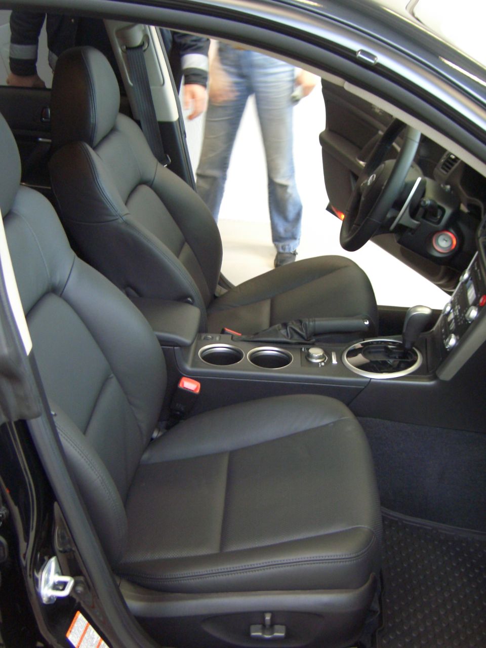 Black leather seats and center console of a car interior