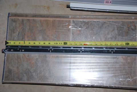 1996 Ford Bronco - Measuring tape shows length of metal track and textured material.