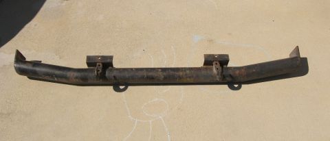 1974 Ford Bronco - This is a rusted front bumper, likely for an older vehicle, shown outdoors.