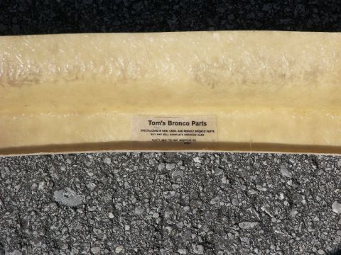 1974 Ford Bronco - This fiberglass part is labeled 'Tom's Bronco Parts', specializing in new, used, and rebuilt Bronco parts.