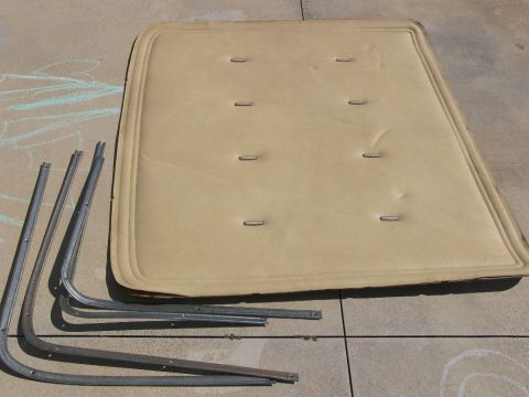 1974 Ford Bronco - Upholstered panel and metal trim pieces laid out on a concrete surface.