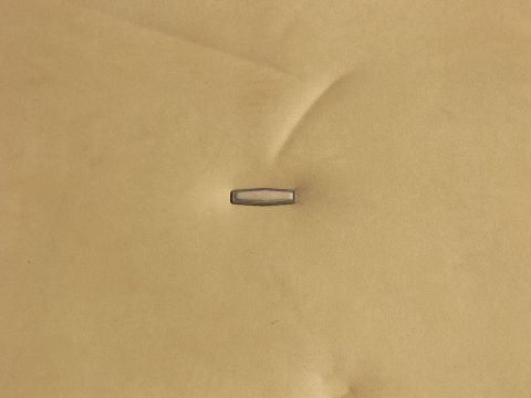 1974 Ford Bronco - A close-up view of the textured tan interior upholstery with a single chrome accent piece visible.