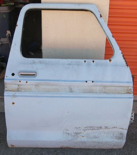 1974 Ford Bronco - This is a light blue pickup truck door with visible rust and trim stripes.