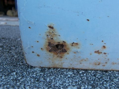 1974 Ford Bronco - A close-up view shows significant rust damage on a vehicle's exterior panel.