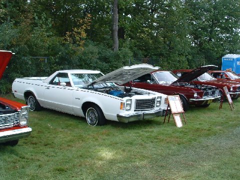1973 Ford Ranchero - White Ford Ranchero with hood open at an outdoor car show.