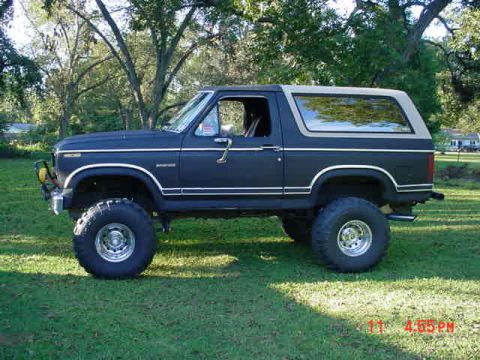 1984 Ford Bronco - This 1980s Ford Bronco, likely from the early 1980s, is shown in a side profile with its distinctive two-tone paint scheme and off-road tir…