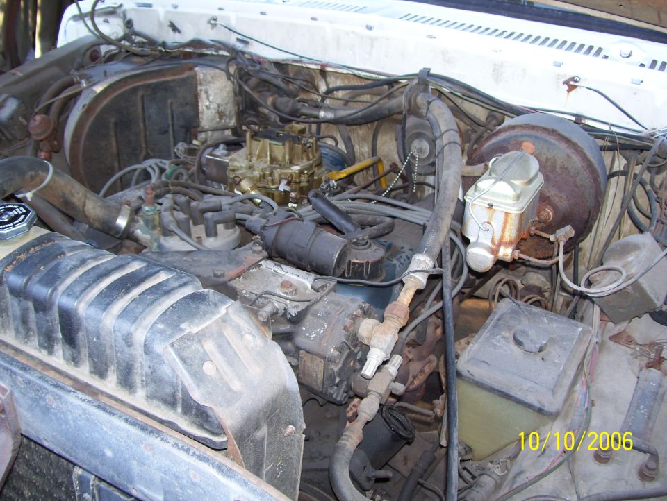 Engine bay with carburetor, brake booster, and radiator shroud visible. Date stamp 10/10/2006