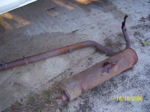 1978 Ford Bronco - This old exhaust system is heavily rusted and damaged, with holes in the muffler.