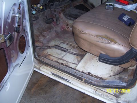 1978 Ford Bronco - Driver's-side interior of a stripped square-body Ford truck with the door open, dated 10/10/2006, showing a bare painted floor pan with sur…
