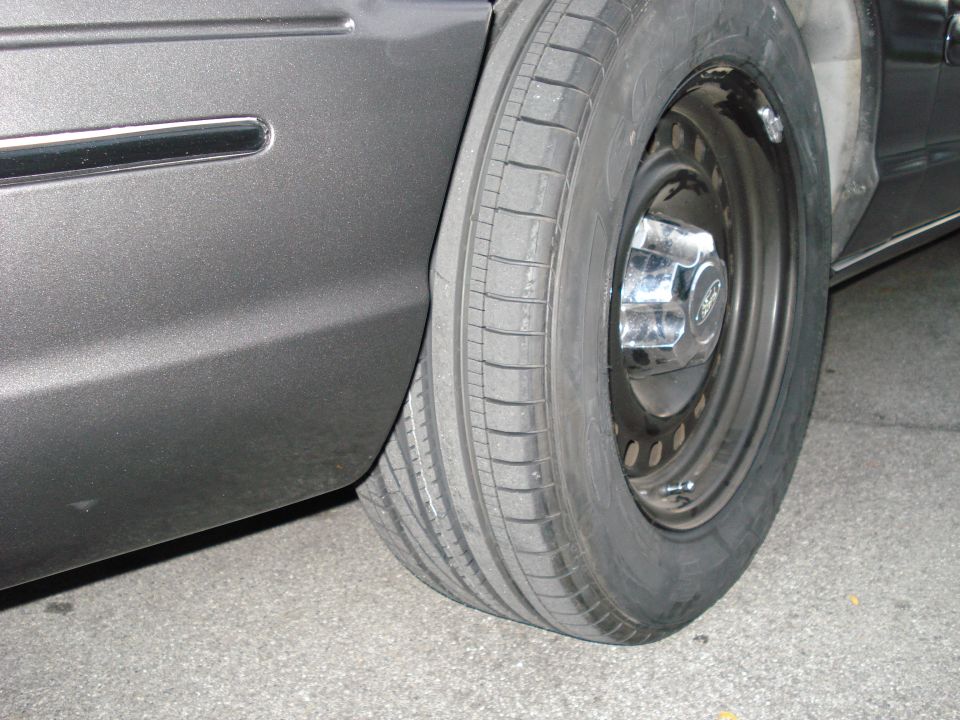 2000 Ford Crown Victoria side view showing rear wheel and lower fender