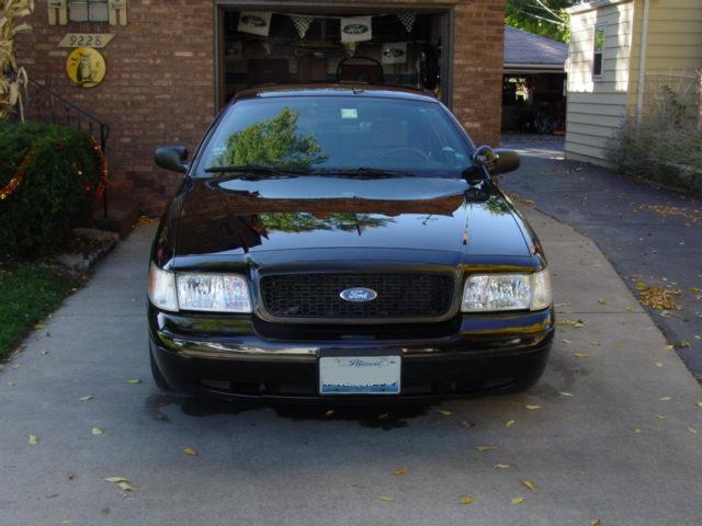 Black 2003 Ford Crown Victoria parked in driveway, front view