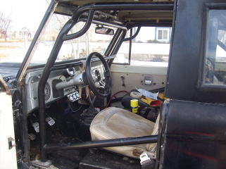 1972 Ford Bronco - The interior of a 1972 Ford Bronco shows a roll cage and custom modifications.