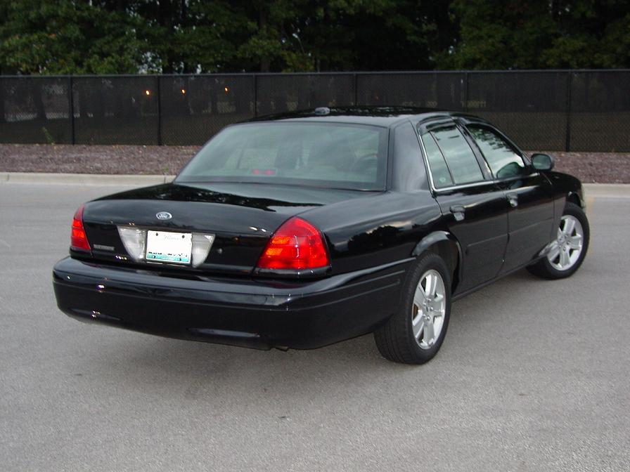 Black 2003 Ford Crown Victoria sedan, rear 3/4 view, clean condition