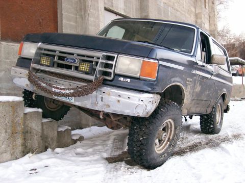 1988 Ford Bronco - This 1988 Ford Bronco 4x4 navigates an obstacle course of concrete blocks and snow, its front bumper adorned with chains.