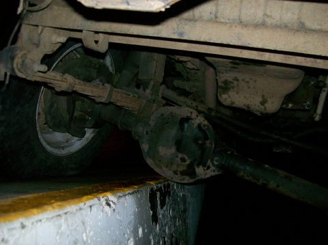 1988 Ford Bronco - Close-up of the rear axle assembly, showing the leaf springs and part of the tire.