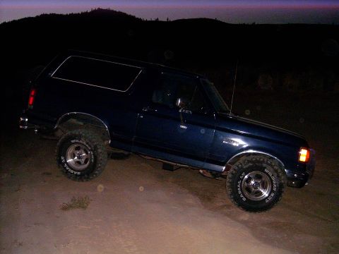 1988 Ford Bronco - This 1988 Ford Bronco is seen from a 3/4 front angle on a dirt road as twilight settles.