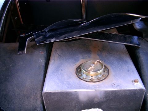 1978 Ford Mustang II - Close-up view of an aftermarket fuel tank and trim components inside a vehicle.