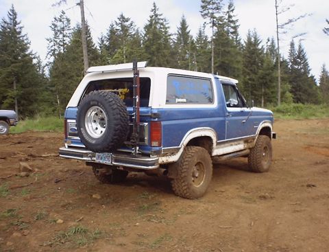 1985 Ford Bronco - This 1985 Ford Bronco is shown in a 3/4 front view, with a spare tire mounted on the rear door.