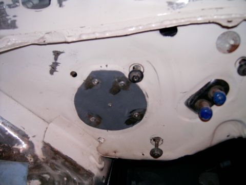 1978 Ford Mustang II - Close-up view of a vehicle's firewall, showing various bolts and fittings, some with blue caps.
