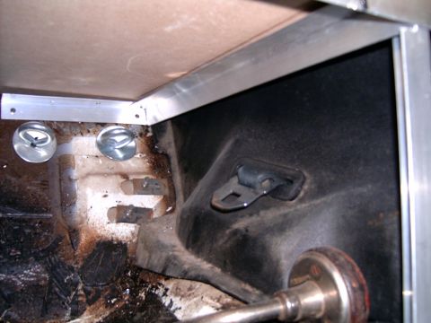 1978 Ford Mustang II - Close-up of the interior of a vehicle's cargo area, showing metal framing and tie-down points.