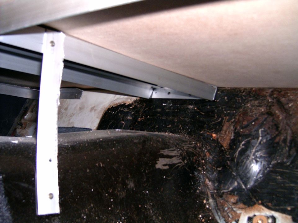 Interior rear wheel well and trunk area with metal bracing