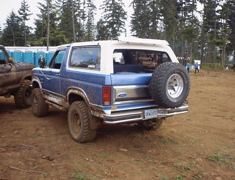 1985 Ford Bronco - This 1985 Ford Bronco is seen from the rear, parked next to another off-road vehicle.