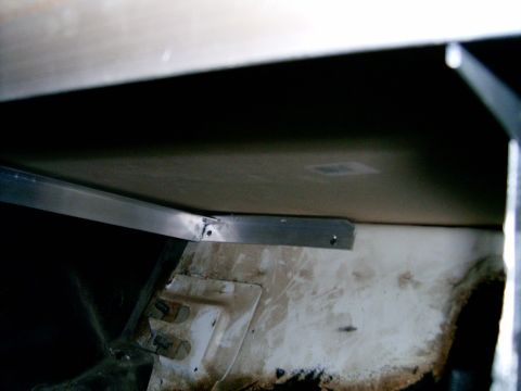 1978 Ford Mustang II - Detail of an underbody structural component, likely a bracket, attached to a panel.