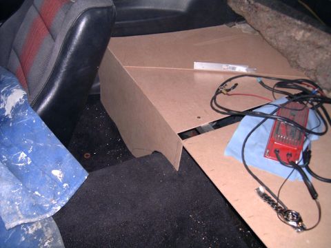 1978 Ford Mustang II - Custom speaker box being installed in a car interior, showing wiring and unfinished MDF panels.
